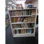 A set of mid 20th century Gibbs Furniture - painted open shelves containing four shelves of books