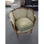 A 20th century beech framed armchair in green brocade