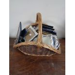 A wicker hand basket and quantity of assorted photograph frames