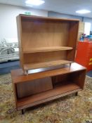 A 20th century teak sliding door sideboard and a set of teak Jonelle open shelves