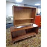 A 20th century teak sliding door sideboard and a set of teak Jonelle open shelves