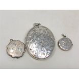 Three silver lockets with engraved decoration