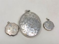 Three silver lockets with engraved decoration