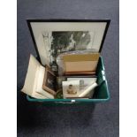 A plastic crate of pictures and prints, monochrome photograph,