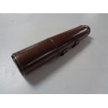 An antique brass leather bound nautical telescope.