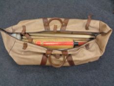 A large leather cricket bag with bats and stumps