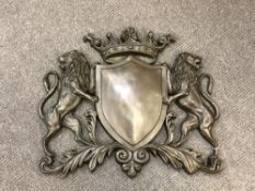 A cast bronze heraldic plaque,