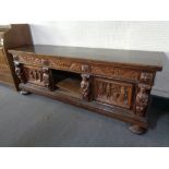 A heavily carved oak sideboard on bun feet a/f CONDITION REPORT: 214cm wide by 61cm