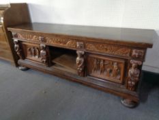 A heavily carved oak sideboard on bun feet a/f CONDITION REPORT: 214cm wide by 61cm