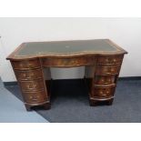 A good quality reproduction twin pedestal desk with tooled leather top