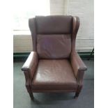 A mid 20th century Danish brown leather wingback armchair