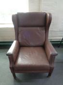 A mid 20th century Danish brown leather wingback armchair