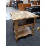 An Edwardian carved oak occasional table