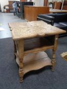 An Edwardian carved oak occasional table