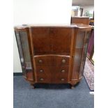 A 1930's side by side walnut bureau display cabinet