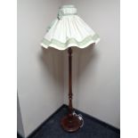 A 20th century stained beech standard lamp and shade