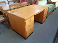 A mid 20th century oak twin pedestal desk