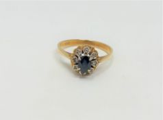 An 18ct gold sapphire and diamond cluster ring, size O CONDITION REPORT: 3.