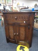 An oak effect corner cupboard