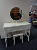 A contemporary white dressing table fitted with a drawer with circular mirror and stool