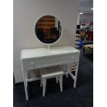 A contemporary white dressing table fitted with a drawer with circular mirror and stool