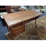 A mid century teak desk fitted with three drawers CONDITION REPORT: Cosmetically