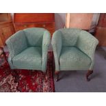 A pair of 20th century tub chairs in green floral fabric