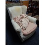 An antique horsehair wing backed chair with loose covers