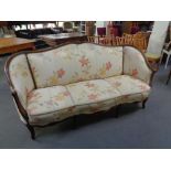 A French style wooden framed settee in cream floral fabric