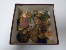A box of military buttons, cap badges,