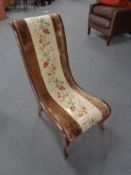 An antique mahogany framed nursing chair