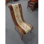 An antique mahogany framed nursing chair