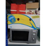 A Daewoo microwave and a box of blender,