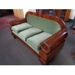 An antique mahogany framed hall settee in green dralon