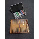 A cased backgammon set and a case of poker chips