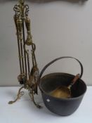 A four piece Victorian brass fire companion set on stand.