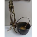 A four piece Victorian brass fire companion set on stand.