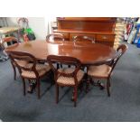 A good quality carved reproduction mahogany twin pedestal dining room table together with six
