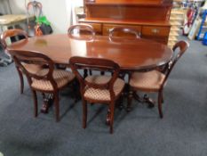 A good quality carved reproduction mahogany twin pedestal dining room table together with six