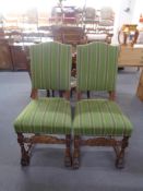 A pair of carved oak high back chairs