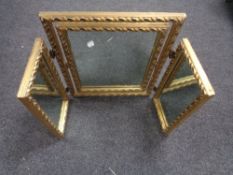 A gilt triplex dressing table mirror
