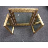 A gilt triplex dressing table mirror
