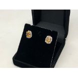 A pair of diamond and citrine cluster earrings
