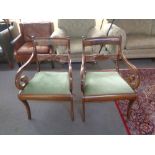 A pair of early 20th century scroll arm armchairs