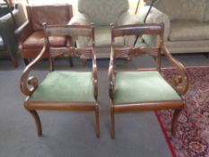 A pair of early 20th century scroll arm armchairs