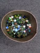 A tin of vintage marbles