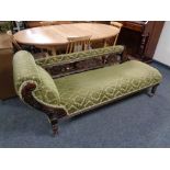 An antique chaise longue in green fabric