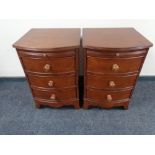 A pair of contemporary bow fronted three drawer bedside chests with slide