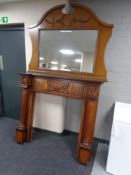 An oak veneered fireplace with overmantel mirror