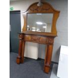 An oak veneered fireplace with overmantel mirror